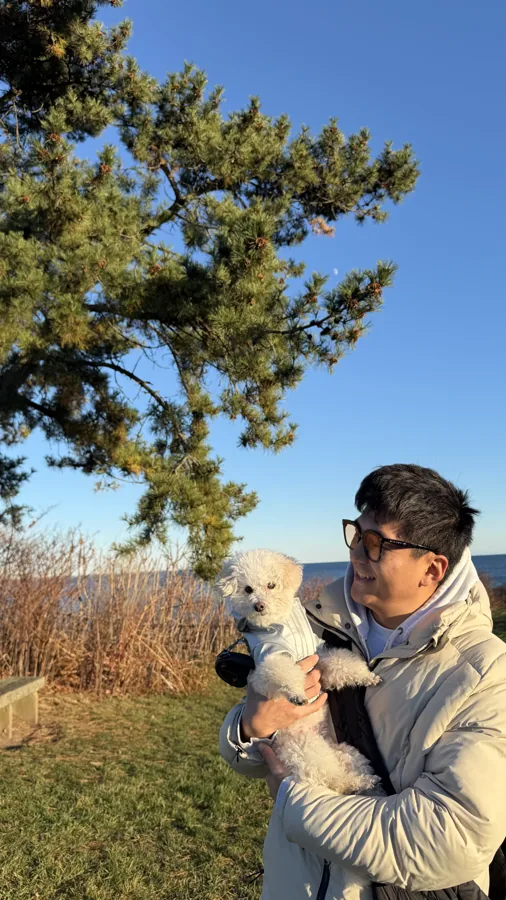 Kelvin with a camera among autumn foliage in Newport, Rhode Island